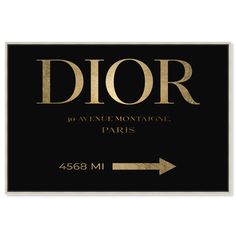 a black and gold sign that says dior with an arrow pointing to the right