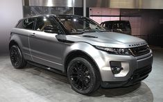 a silver range rover is on display at an auto show