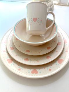 a stack of plates with cups and saucers sitting on top of eachother