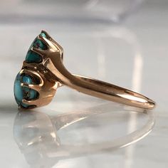 Details: Sweet vintage turquoise 14K ring. The stones are a lovely bright blue color with veins. The band is stamped 14K. The stones measure 5-6mm. Please ask all necessary questions prior to placing an order. Measurements: The size is 6 US, and can be sized for a fee. Condition: The overall all condition of this ring is very good. Turquoise Ring With Patina For Anniversary, Anniversary Turquoise Ring With Patina, Antique Yellow Gold Turquoise Ring For Anniversary, Classic Yellow Gold Turquoise Ring, Heirloom Turquoise Ring For Anniversary, Antique Turquoise Ring In Yellow Gold, Antique Blue Turquoise Ring For Anniversary, Turquoise Round Opal Ring In 14k Gold, Turquoise Opal Ring In 14k Gold