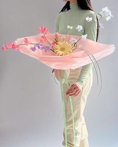 a woman holding a pink umbrella with flowers on it