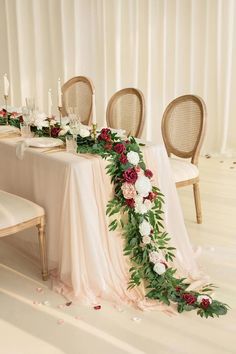 a table with flowers and candles on it is set up for a formal dinner or reception