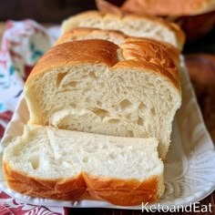 two loaves of bread on a white plate