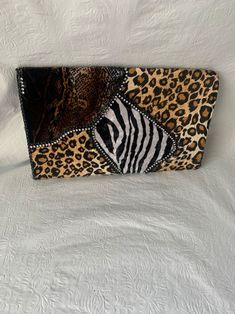 an animal print purse on a white sheet