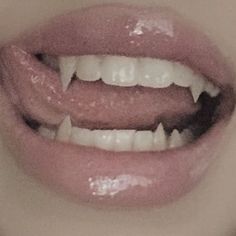 a woman's mouth with white teeth and pink lipstick