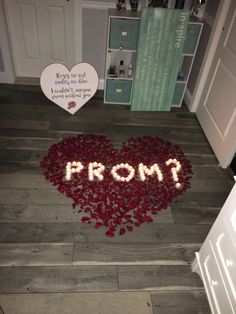 a heart - shaped room with the word prom spelled in white frosting on the floor