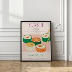 a poster with sushi on it in front of a white wall and wooden floor