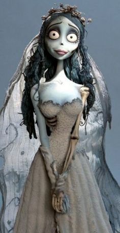 a corpse bride doll wearing a veil and dress