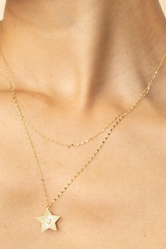 Featuring a doubled 14k gold mirror chain, our Starburst Layered Necklace offers a sleek layered look without the work. A cubic zirconia heart shimmers within a diamond cut solid gold star for a pendant that shines bright day or night! Metal: 14k Yellow Gold Chain Weight and Thickness: 2.1 Grams - 0.9mm Thick Pendant Dimensions: 18mm long, 16mm wide Length: Chain 1, 15-16 Inches Long, Chain 2, 17-18 Inches Long Stones: White Cubic Zirconia Stones Origin: Crafted in Vicenza, Italy Dainty Yellow Gold Double Chain Jewelry, Delicate Double Chain 14k Gold Jewelry, 14k Gold Double Chain Layering Jewelry, 14k Gold Double Chain Jewelry For Layering, Delicate 14k Gold Double Chain Jewelry, 14k Gold Jewelry With Satellite Chain For Layering, Vicenza Italy, Gold Starburst, Yellow Gold Chain