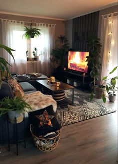 a living room filled with furniture and a fire place in the middle of the room