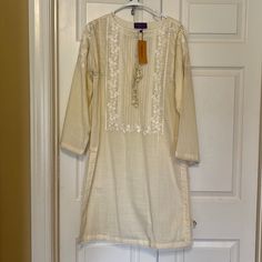 Sana Safinaz Embroidered Essentials Kurta In Cream. Perfect For Eid / Spring / Summer. New With Tag In Size Medium. Off White Straight Kurta For Spring, Summer Festive Kurta With Back Tassel Tie-up, Unstitched Cream Kurta For Summer, Bohemian Off White Straight Kurta, Festive Long Sleeve Kurta With Back Tassel Tie-up, Traditional Cotton Kurta With Back Tassel Tie-up, Cream Cotton Salwar Kameez For Spring, Elegant Straight Kurta Tunic For Summer, Spring Cream Cotton Salwar Kameez