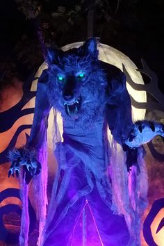 a large blue monster statue with glowing eyes