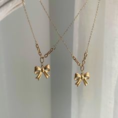 Get ready to sparkle this holiday season with your cutest gold bow necklace! It's the ideal accessory to brighten up any celebration! ♡MATERIAL♡ 18k gold PVD coating on stainless steel, this necklace is anti-tarnish and waterproof, you can wear it 24/7. ♡CHAIN LENGTH♡ 15" + 2" extender, necklace can be adjusted to 17" max. Model is wearing 15" in the picture. ♡PENDANT MEASUREMENT♡ 15mm*15mm(W*H) ♡SHIPPING♡ - We ship the next business day - Canada: 2-15 business days - U.S orders : 4-6 business days  - U.K orders : 4-10 business days  - Rest of the world : 5-15 business days Cute Gold Charm Necklaces With Clavicle Chain, Cute Gold Charm Necklace With Clavicle Chain, Gold Necklace With Ribbon For Gift, Gold Necklace With Ribbon Perfect For Gifts, Adjustable Necklace With Decorative Bow For Gifts, Adjustable Necklace With Decorative Bow As Gift, Cute Gold Necklaces For Party, Gold Bow Necklaces For Gifts, Gold Necklaces With Bow For Gifts