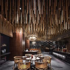 the interior of a restaurant with wooden walls and ceiling lights hanging from the rafters