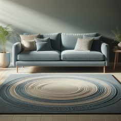 a living room with a blue couch, rug and potted plant on the floor