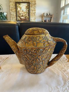 a brown tea pot sitting on top of a table