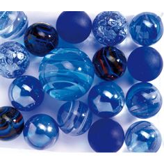 blue and black marbles are arranged on a white surface