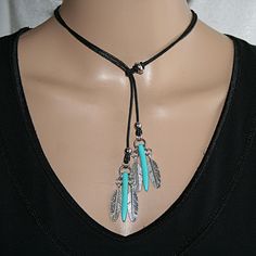 Extravagant necklace with 4 feather pendants, 2 bar stone beads in turquoise and cotton cord The pendants are pulled through the loop of the ribbon and the length can be individually adjusted up to a neck width of approx. 45 cm. A fashionable jewelry companion for many occasions. Adjustable Feather Necklace As Gift, Adjustable Feather Jewelry For Festivals, Adjustable Bohemian Necklaces With Feathers, Adjustable Turquoise Jewelry With Feathers, Adjustable Feather Festival Jewelry, Vial Necklace, Boho Style Necklaces, Easy Jewelry, Feather Pendant