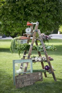 a garden stand with vegetables on it in the grass