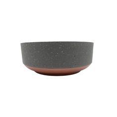 a gray and brown bowl sitting on top of a white table