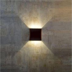 a square light that is on the side of a wall