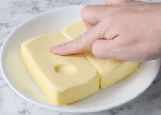 a person is picking up some butter from a bowl