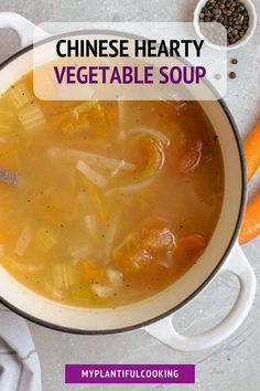 a white bowl filled with soup next to carrots and seasoning on a table