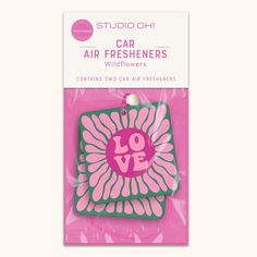 a package of air fresheners with the words love in pink and green on it