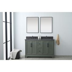 two mirrors are hanging on the wall above a double sink vanity in a white bathroom