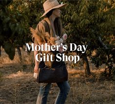 a woman carrying a black purse and flowers in her hand with the words mother's day gift shop