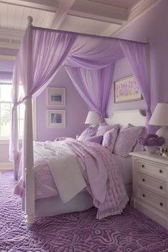 a bed with purple sheets and pillows in a bedroom next to a white chest of drawers