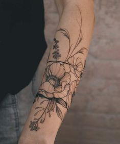 a person with a flower tattoo on their arm