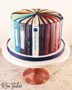 a cake decorated with books on top of a table