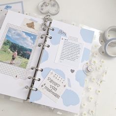 an open scrapbook with pictures and writing on it, next to some washi tape