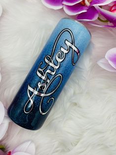 a blue tumbler with the words fresh as can be on it next to flowers