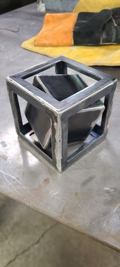 This is an extremely fun DIY welding kit that includes parts for a 3 inch cube, a 4 inch cube, 3 inches of 1/4" rod and 4 legs cut 3/4" long. The builder will have to make the 3 inch cube fit inside the 4 inch cube and use the rod to balance it perfect then weld up so it Spins inside. Great for MIG or TIG welders. Parts are raw and need to be cleaned up. Includes all parts necessary to build. Cut the 1/4" rod in half and tack on opposite corners. balance it perfect and then weld in place. measure and sharpen the ends of rods and make your lengths and balance spot on.  Requires a, Welder  Grinder  Pad sanders and cut off wheel.  Square and level. Welding Jig, Cool Welding Projects, Metal Welding Art, Welding Shop, Tig Welder, Diy Welding, Door Design Modern, Metal Welding, Shop Layout