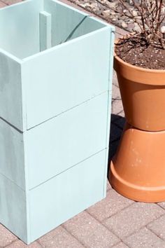 a planter sitting next to a potted plant