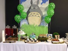 a table topped with lots of food and balloons