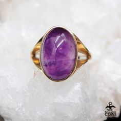 Metal: 9k Yellow Gold Weight: 4.56 grams Size: 5.5 US Stones: Amethyst *Make a statement with this eye-catching cocktail ring, showcasing a stunning Amethyst gemstone set in a lovely 9k yellow gold setting. Despite its vintage charm, this piece is in excellent condition with minimal wear or patina. Don't pass up the opportunity to add this timeless beauty to your collection! *P L E A S E * S E E * P H O T O S !! Fine Jewelry Purple Amethyst Cabochon Ring, Cabochon Amethyst Ring In Fine Jewelry Style, Purple Amethyst Cabochon Ring Fine Jewelry, Cabochon Amethyst Ring Fine Jewelry, Formal Spiritual Amethyst Ring, Yellow Gold Amethyst Cabochon Ring, Collectible Yellow Gold Amethyst Ring, Formal Purple Amethyst Spiritual Ring, Formal Spiritual Purple Amethyst Ring