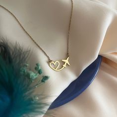 Heart and Airplane Necklace - Heart Flying Necklace - Gift for Travel Lover - Gift for Pilot - Stewardess Gift - Traveler's Necklace - Modern Jewelry - Best Friend Gift's - Valentine's Day Gift Introducing our Heart and Airplane Necklace, the perfect gift for pilots or a delightful hostess gift. This exquisite necklace combines elegance with a touch of wanderlust, making it a unique and thoughtful present for aviation enthusiasts or those who love to travel. Material - High Quality Handmade 925 Sterling Silver - 18K Gold Plated and 18K Rose Plated - High Quality Handmade 8K REAL GOLD and 14K REAL GOLD - 8K & 14K REAL ROSE GOLD and 8K & 14K REAL WHITE GOLD Preparation and Shipping : - The processing time of all our products is 3-5 working days. - You can send us a message for fast shipping Unique Gift Ideas For Best Friend, Pilot Necklace, Pilot Jewelry, Gifts For Pilot, Aviation Jewelry, Necklace Photography, Airplane Jewelry, Airplane Necklace, Valentine Gifts Jewelry