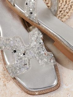 Sparkling Silver Stride: Chic Flat Sandals for Women Sparkling Synthetic Open Toe Sandals, Sparkling Open Toe Synthetic Sandals, Silver Open Toe Synthetic Sandals, Spring Silver Flat Heel Sandals, Summer Shimmer Open Toe Sandals, Summer Open Toe Sandals With Shimmer, Silver Open Toe Sandals For Vacation, Vacation Silver Open Toe Sandals, Summer Synthetic Sandals With Shimmer