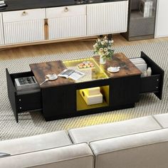 a living room with couches, coffee table and kitchen in the backround