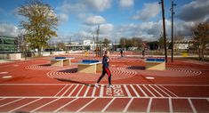 a man standing on top of a red running track