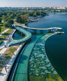 an aerial view of a bridge over water with green algae growing on the bottom and sides