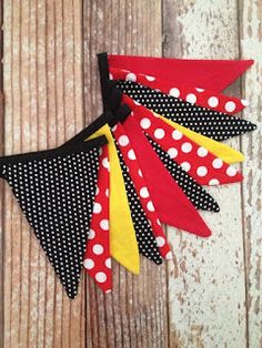 the bunting banner is decorated with polka dots and black, yellow, red, and white ribbons