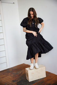 Thoughtfully crafted from ethically-sourced handwoven cotton and defined by its movement-enhancing tiered ruffles, this Short Sleeved Tiered Midi Dress is a timelessly elegant piece that will enliven your wardrobe. Effortless and flouncy, this ruffle dress falls midi length with arm coverage as well. Shop MULXIPLY.COM | Photo by @meredithbrockington1 Fall Midi, Black Ruffle Dress, Tiered Ruffle Dress, Tiered Midi Dress, Black Ruffle, Black Midi Dress, Fall Dresses, Ruffle Dress, Spring Summer Fashion