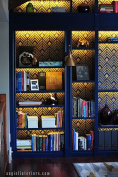 a bookshelf filled with lots of books in a room