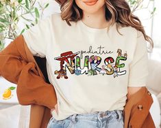 a woman wearing a white shirt with the words nurse on it