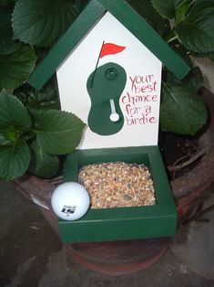 a bird house with a golf ball in it