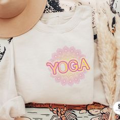 We just love this mandala yoga crop top! It's perfect for practitioners or as a gift to someone who loves yoga. This fitted shirt is breathable and lightweight, so it can be worn with pants and shorts during all seasons of the year. The soft fabric will keep you comfortable as you move through your sun salutations, downward dogs, and kirtan verses. Yoga | Yoga Aesthetic | Yoga Clothes | Yoga Lifestyle | Yoga Outfit For Women | Yoga Outfit Ideas | Yoga Style Fashion | Yoga Wear | Mandala Lotus Mandala Lotus